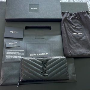 YSL ZIP AROUND EMBOSSED BLACK LOGO WALLET.